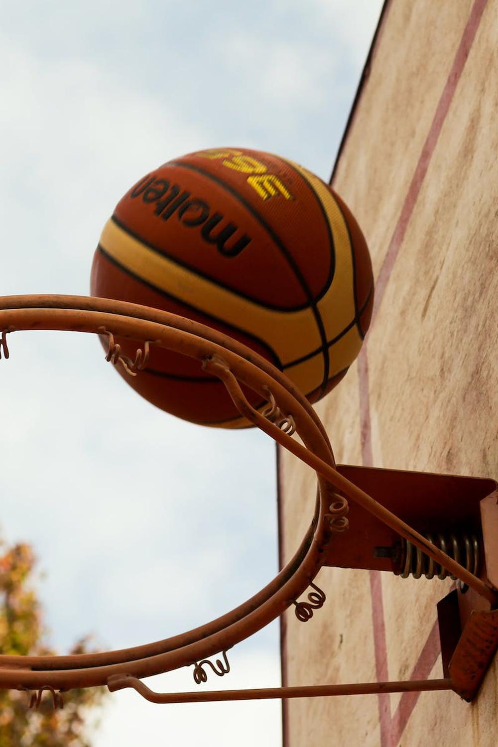 brown_basketball_above_steel_basketball_hoop